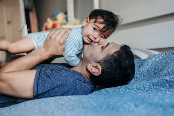 istock Handsome father enjoying with his baby boy at home 1283493436