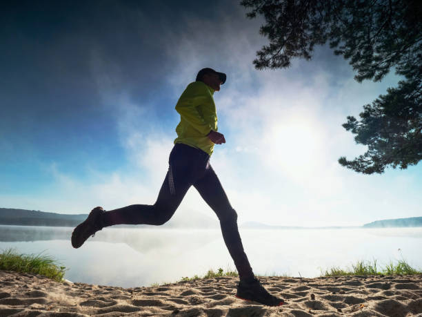 istock Runner athlete running on sand.  Man fitness workout 1283497863