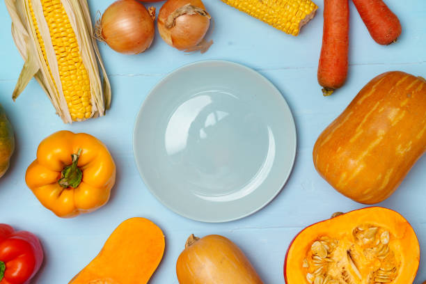 istock Variety of vegetables including pumpkins on blue pastel background 1283497937
