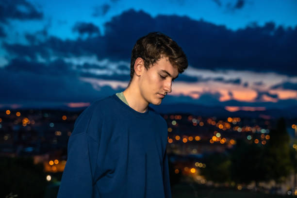 istock Young man with evening city views 1283498437