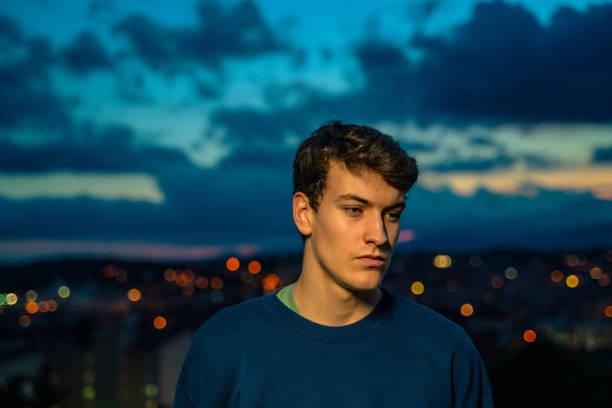 istock Young man with evening city views 1283498440