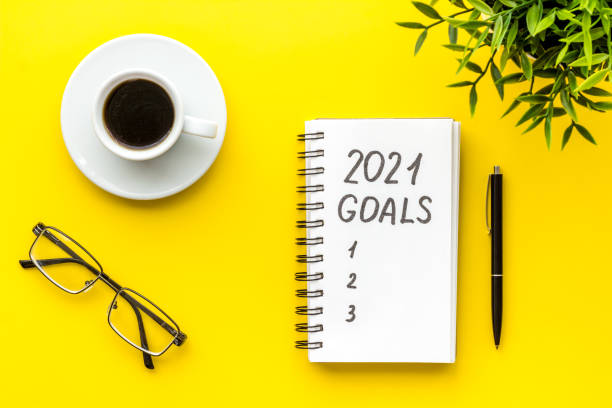 istock New year goals list. Christmas decorations and notebook on a table, flat lay 1283498480