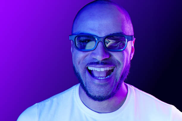 istock Positive black man in glasses posing in neon lights 1283499832