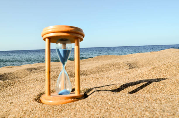 istock Hourglass Clock on the Sand Beach 1283499946