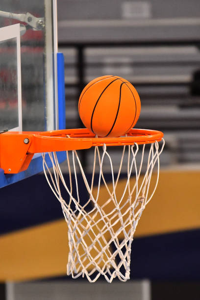 istock Ball falling through a Basketball Hoop 1283500010