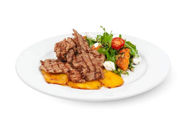 istock Grilled beef slices with fried potatoes on white background 1283500099
