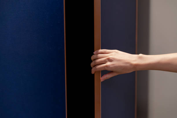istock Closeup hand open wardrobe or cupboard door. 1283500396