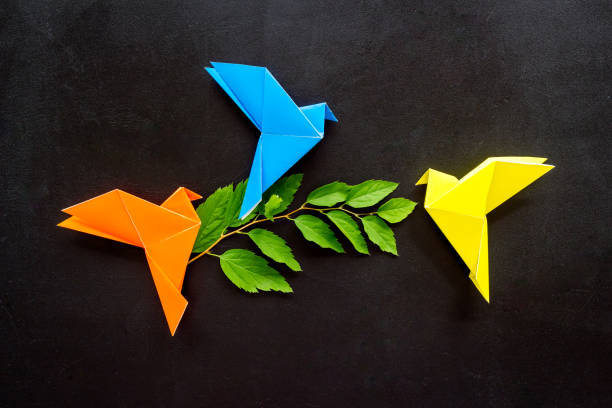 istock Colored origami - paper birds with leaves, overhead view 1283500403