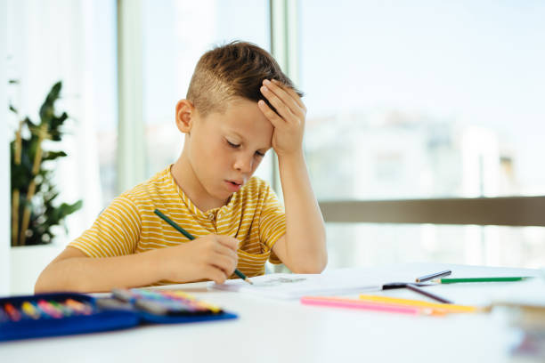 istock Young boy doing his homework. Back to school. Online class from home. 1283503522