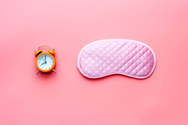istock Sleeping mask with alarm clock, flat lat,top view 1283504571
