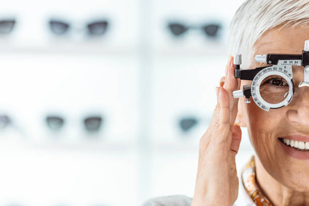 Your health is a serious subject around here Senior beautiful woman checking her sight at ophthalmologist with Eye Test Equipment. optometrist stock pictures, royalty-free photos & images