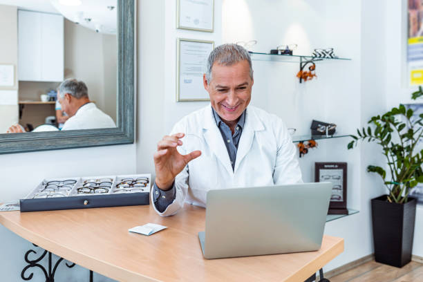 istock Happy ophthalmologist sitting at desk 1283504632