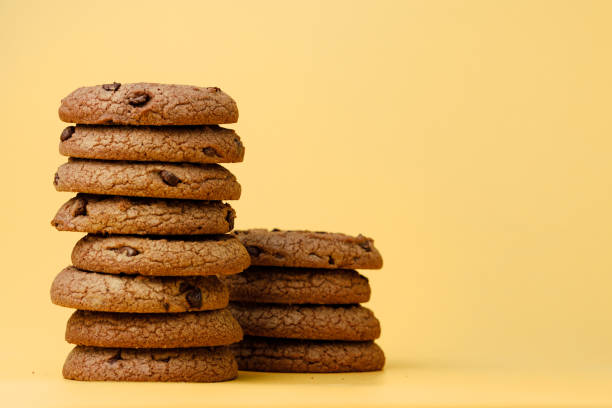 istock Pile of chocolate chip cookies on yellow backgreound 1283504810