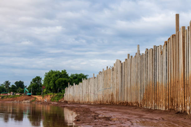 istock Numerous concrete pillars form a wall to protect the riverbank. 1283504863