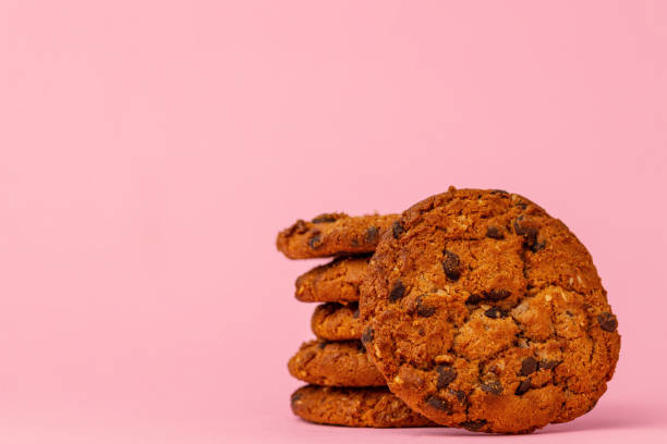 istock Stacked chocolate chip cookies against pink background 1283504914