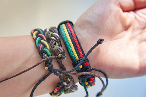 istock Three bracelets made of fabric and leather ropes on a woman's hand. 1283505230