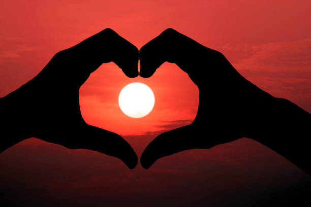 istock Silhouette of hand made heart symbol 1283506295