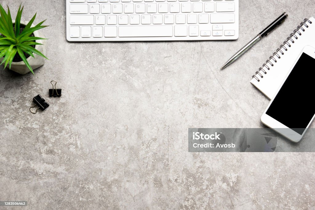 White desk office with laptop, smartphone and other work supplies with cup of coffee. Top view with copy space for input the text. Designer workspace on desk table essential elements on flat lay. Desk Stock Photo