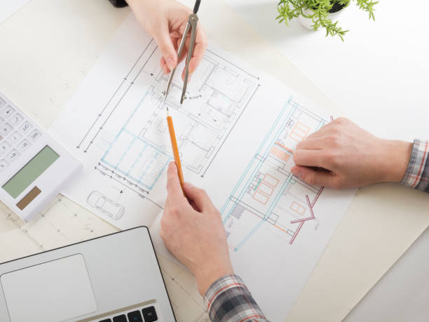 architects working on blueprint, real estate project. architect workplace - architectural project, blueprints, ruler, calculator, laptop and divider compass. construction concept. engineering tools. - housing project organization meeting real estate imagens e fotografias de stock