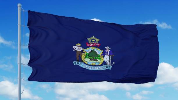istock Maine flag on a flagpole waving in the wind, blue sky background. 3d rendering 1283509538