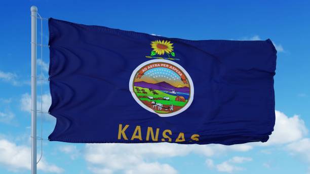 istock Kansas flag on a flagpole waving in the wind, blue sky background. 3d rendering 1283509613