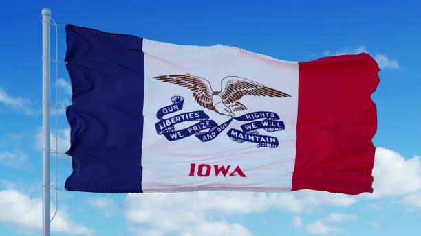 istock Iowa flag on a flagpole waving in the wind, blue sky background. 3d rendering 1283509627