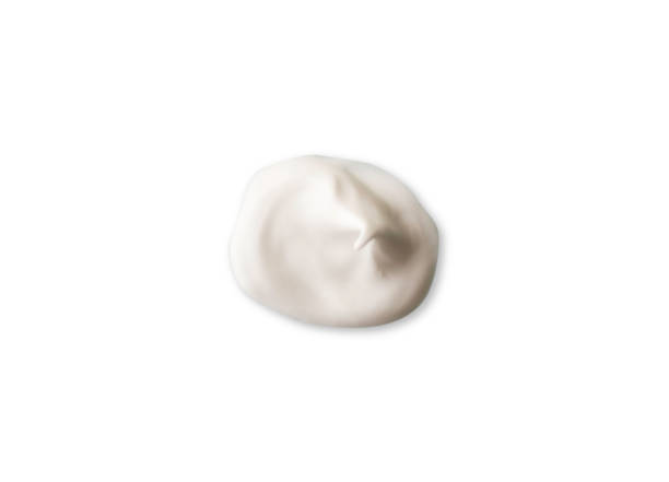 istock Color corrector strokes isolated on white background. White cream smudge smear swatch sample. Makeup foundation creamy texture. 1283509642