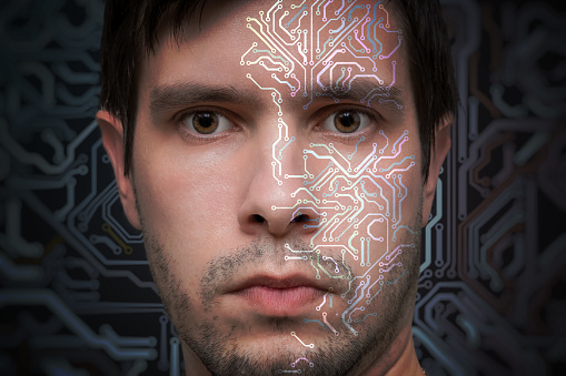 Artificial intelligence concept. Face of man with electronic circuit.