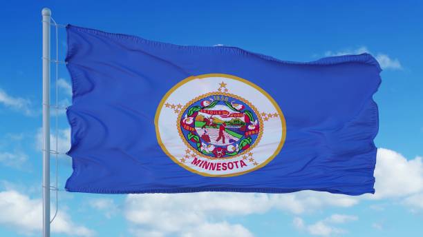 istock Minnesota flag on a flagpole waving in the wind, blue sky background. 3d rendering 1283510034