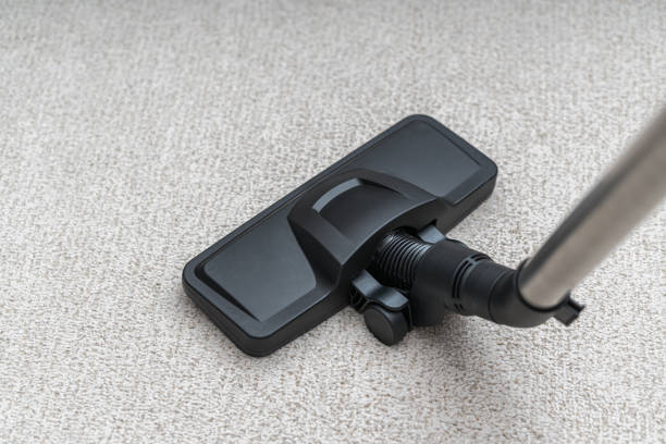 istock Vacuum cleaner is cleaning dust from carpet. Housework cocnept. 1283510121