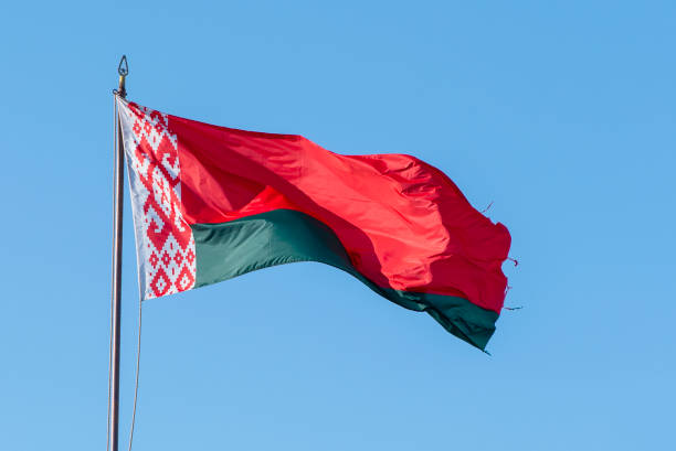 istock Flag of Belarus waving against blue sky 1283510935
