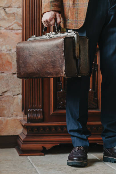 istock Leather bag in man hand close up 1283512441