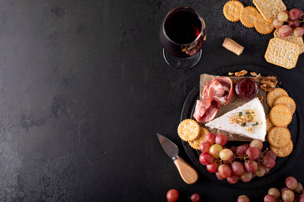 istock piece of brie cheese with grapes, crackers and red wine 1283514145