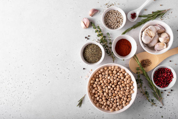 istock dried chickpeas in a white bowl with spices and herbs on a white table 1283514556