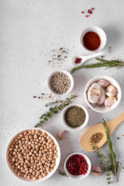 istock dried chickpeas in a white bowl with spices and herbs on a white table 1283514590