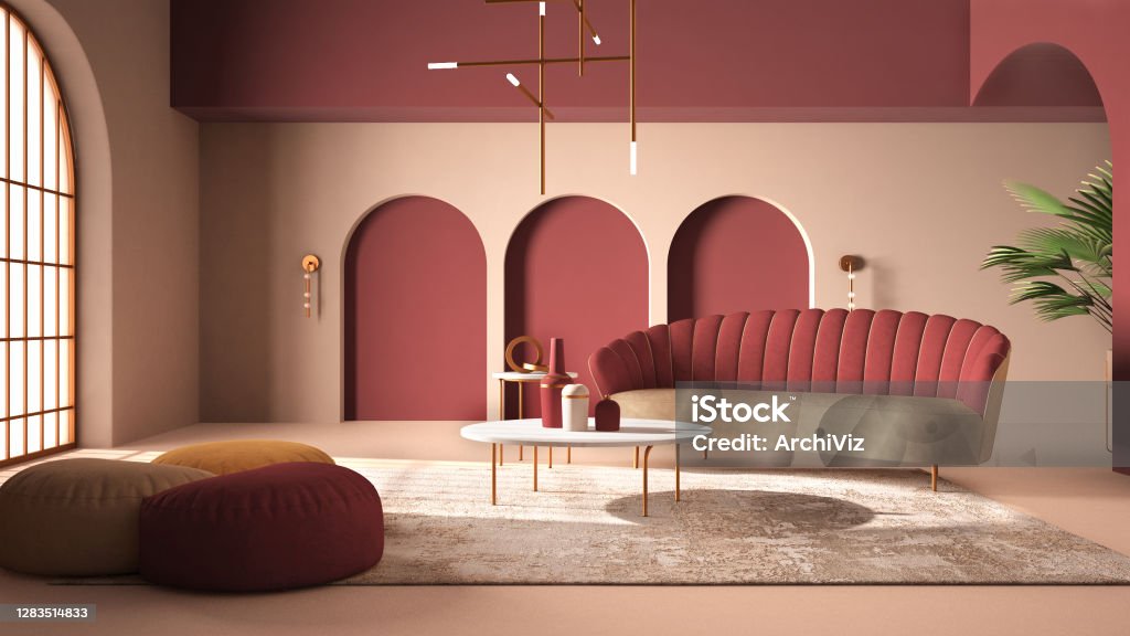 Elegant classic living room with archways and arched window and door. Red sofa with poufs, carpet, pendant lamp, coffee tables, vases, decors. Modern interior design idea Apartment Stock Photo