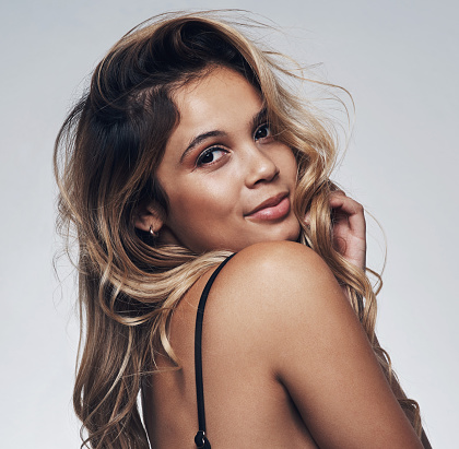 Cropped shot of a beautiful young woman posing against a grey background