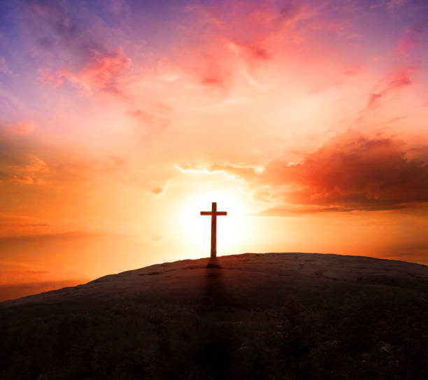 istock Good Friday concept: Silhouette cross on  mountain sunset background 1283515772
