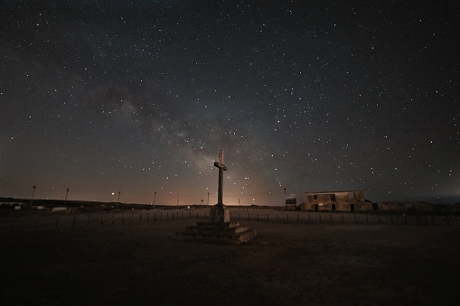 Photo of the Milky Way Galaxy over a cross in the Cabo Espichel cape in Portugal.