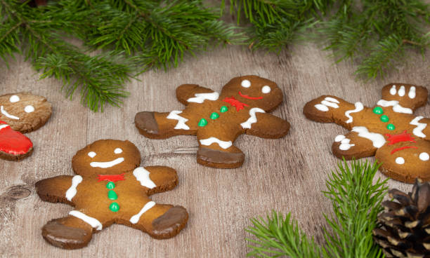 istock gingerbread men on a wooden surface decorated with spruce branches. selective focus. traditional Christmas gingerbread cookies. holiday treats 1283518954