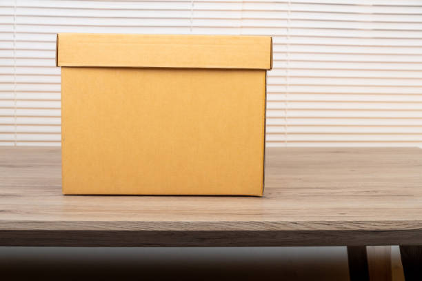 istock A brown box delivery placed on a wooden table for packaging 1283519311