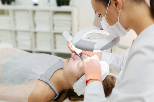 istock A professional beautician performs a mechanical facial cleansing procedure at the spa. Beautiful caucasian woman on a cosmetic procedure. health Center 1283519478