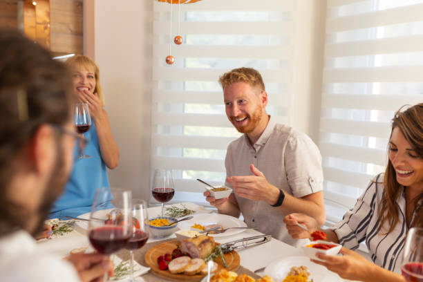 istock Friends having Thanksgiving dinner party at home 1283520142