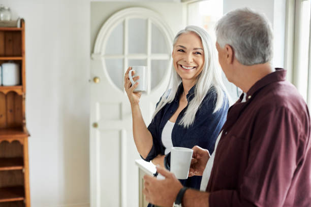 istock Smiling mature couple having coffee at home 1283520604