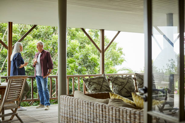 istock Mature couple with wine talking in balcony 1283520691