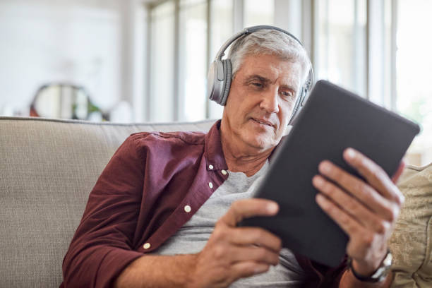 istock Mature male using digital tablet at home 1283520791