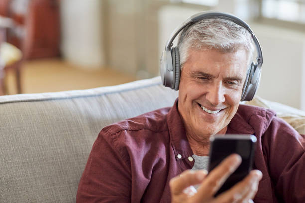 istock Mature male using smart phone at home 1283520831