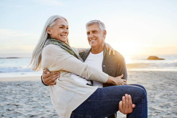 istock Happy mature couple at beach during vacation 1283520848