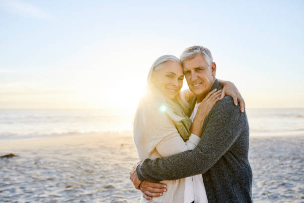 istock Woman embracing man at beach during sunset 1283520880