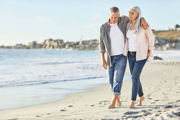 istock Romantic couple in casuals walking at beach 1283520893